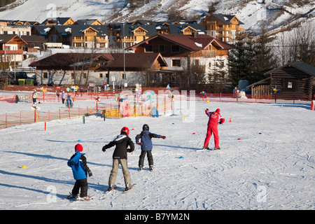 Children learning on ski school nursery slopes in Alpine resort in Austrian Alps in winter. Rauris Austria Europe Stock Photo