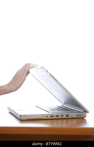 Hand closing the white laptop. Concept of opening and closing the ...