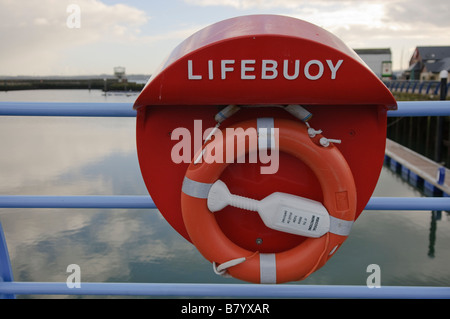 Lifebuoy on a blue fence Stock Photo