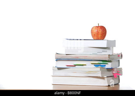 An apple on top of a stack of books  Stock Photo