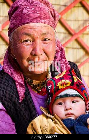 Kyrgyz grandmother and kid in a yurt Near Irkestan pass Kyrgyzstan Stock Photo