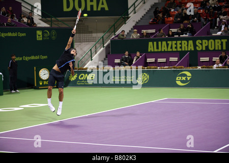 Roger Federer or Switzerland playing Andreas Seppi of Italy on Jan 7 2009 in the Qatar ExxonMobil Open Stock Photo