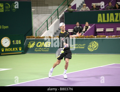 Andreas Seppi of Italy playing Roger Federer of Switzerland on Jan 7 2009 in the Qatar ExxonMobil Open Stock Photo