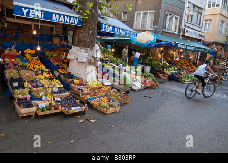 Bicyclist rides by grocer on Buyukada Stock Photo