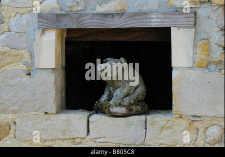 stone pig sitting in a barn window Stock Photo