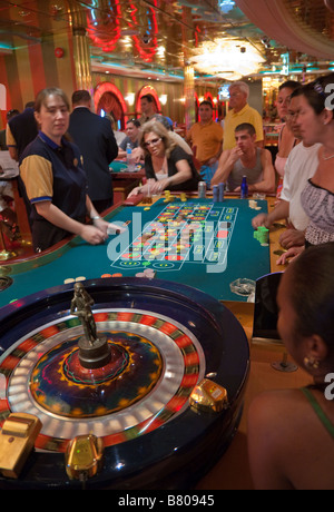 Gamblers playing roulette in casino on Royal Caribbean Navigator of the Seas cruise ship Stock Photo
