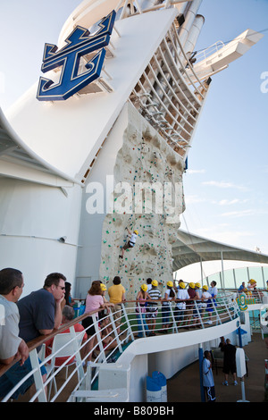 Teenage boy climbing artificial rock wall onboard Royal Caribbean Navigator of the Seas cruise ship Stock Photo
