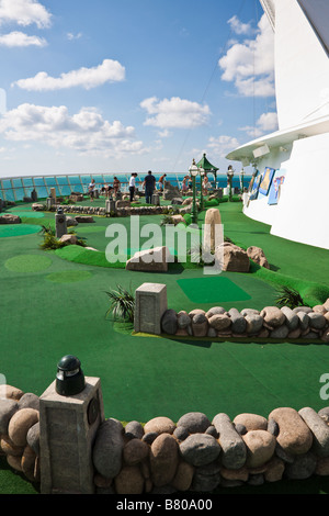 Cruise guests play miniature golf on the deck of the Royal Caribbean Navigator of the Seas cruise ship Stock Photo