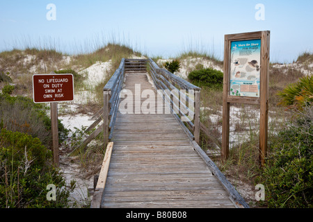 Signs at beach entrance warn of rip currents and disallow pets on beach Stock Photo