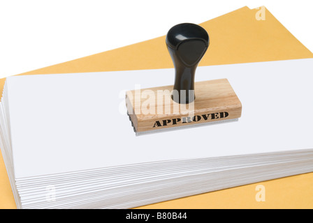 A rubber stamp of approval ready to be used to stamp envelopes Stock Photo