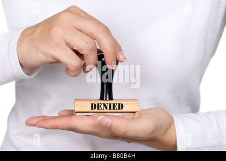 A woman holding a denied authorization stamp Stock Photo