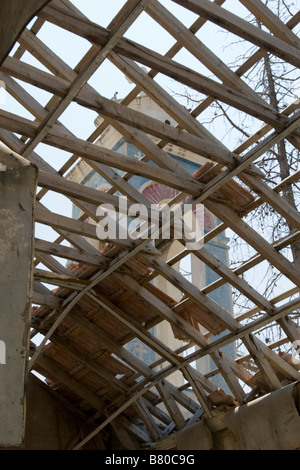 View of belfry tower of Agios Nicolas (Alasa) Church through destroyed church roof sheeting near Kouris Dam. South Cyprus Stock Photo