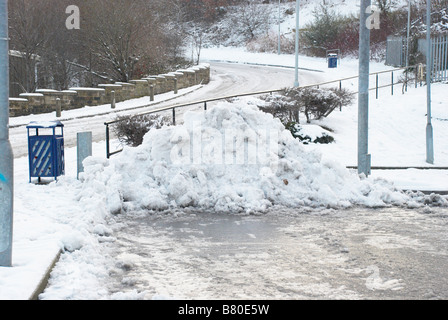 A pile of cleared snow in a car park. Stock Photo