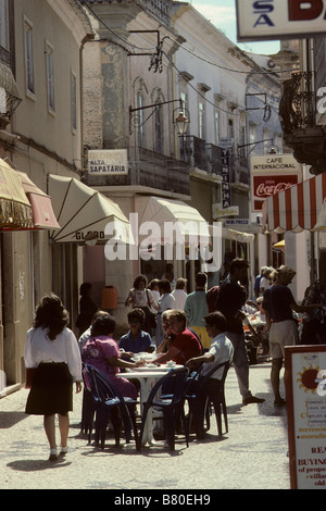 Portugal, Algarve.  Typical street scene: outdoor café in narrow pedestrian shopping street in popular tourist town of Loulé Stock Photo