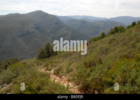 two female hikers on trail, Serra del Penyo, near Benimaurell, Vall de Laguar, Alicante province, Comunidad Valenciana, Spain Stock Photo