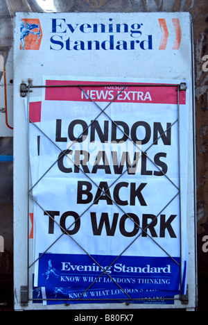evening standard newspaper hoarding with headline london crawls back to work, following heavy snow in early february, 2009 Stock Photo
