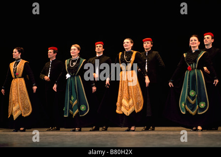 A Croatian Folk Dance Group performing on Stage in Traditional Costume Stock Photo