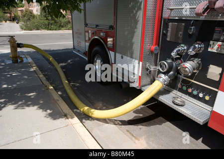 fire truck connected to fire hydrant on the street, southwestern united states Stock Photo