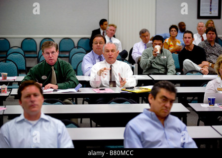 A realtor speaks out at a weekly meeting with his colleagues to inform each other of new property listings in California. Stock Photo