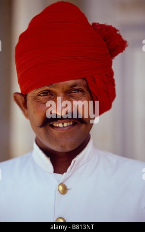 Guard in the city Palace of Jaipur wearing a red turban Stock Photo