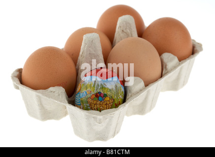 single wrapped small chocolate easter egg placed in an egg carton with 5 free range eggs Stock Photo