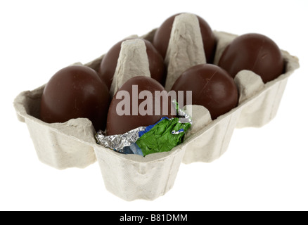 single partially unwrapped chocolate easter egg placed in a box of small unwrapped easter eggs Stock Photo