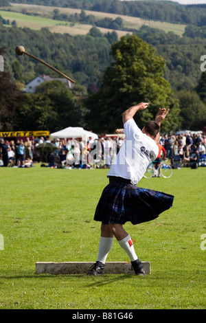 Competitor in the throwing event at the Scottish Highland Games sports field arena in Pitlochry, Scotland, UK Stock Photo