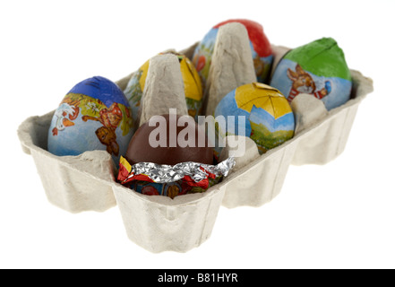 single partially unwrapped chocolate easter egg placed in a box of small wrapped easter eggs Stock Photo