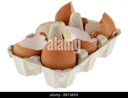 single intact egg in a carton with broken eggs Stock Photo