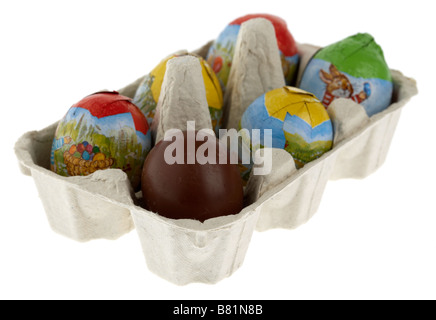 single unwrapped chocolate easter egg placed in a box of small wrapped easter eggs Stock Photo