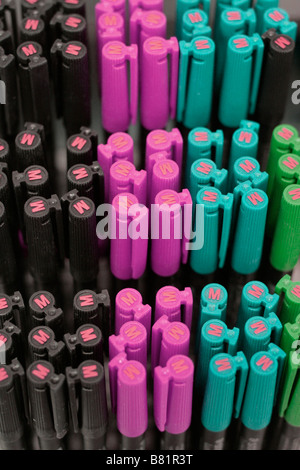 Purple Green and black Coloured pens on display Stock Photo