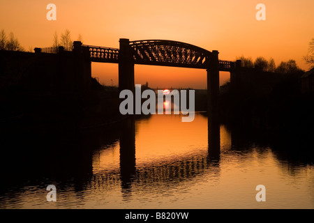 Manchester Ship Canal at sunset with Latchford Railway Viaduct in foreground, Warrington, Cheshire, England, UK, Europe Stock Photo