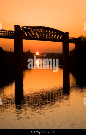 Manchester Ship Canal at sunset with Latchford Railway Viaduct in foreground, Warrington, Cheshire, England, UK, Europe Stock Photo