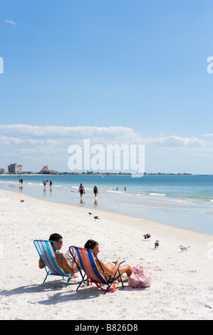 Young couple sitting in deck chairs, St Pete Beach, Gulf Coast, Florida, USA Stock Photo