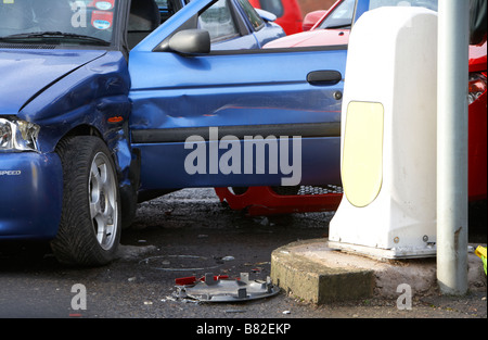 aftermath of a road traffic accident involving two cars and a traffic island bollard in northern ireland uk Stock Photo