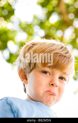 boy showing sad face looking down silly Stock Photo