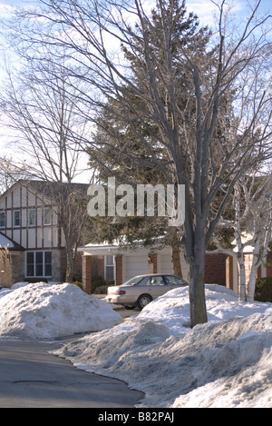 Dirty melting Snow on the side street/Road with Houses at the back in Toronto Canada Stock Photo