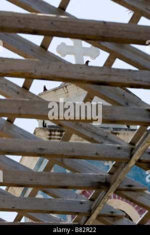 View of belfry tower of Agios Nicolas (Alasa) Church through destroyed church roof sheeting near Kouris Dam. South Cyprus Stock Photo