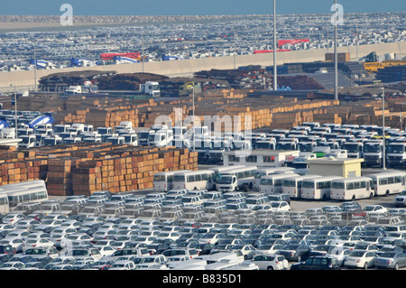 Aerial view of dockside commercial port storage rows of imported new cars & lorry truck buses timber materials Abu Dhab United Arab Emirates UAE Asia Stock Photo