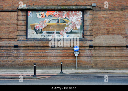 Old Ford Cortina poster from the 70s on a brick wall which was the cinema in Lancaster it is now the Travelodge Stock Photo