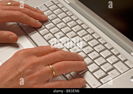 Man using laptop computer keyboard Stock Photo
