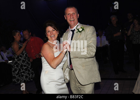 A Newly wed couple dance at their reception party, West Yorkshire Model Released Stock Photo