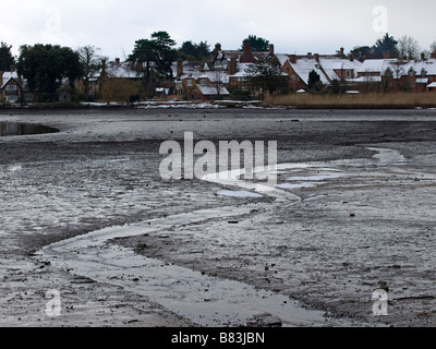 Beaulieu village New Forest Hampshire UK, a view with snow covered roofs and the water drained from the lake. Stock Photo