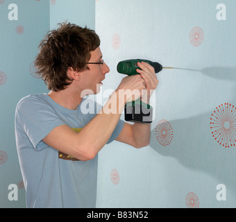 Man using cordless drill Stock Photo