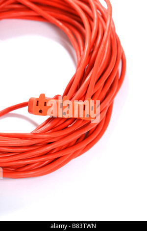A 100 foot orange extension cord coiled up with a three way splitter Stock Photo
