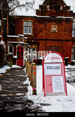 Closed school sign due to the snow Stock Photo