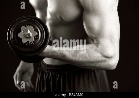 Man working out with hand weights Stock Photo