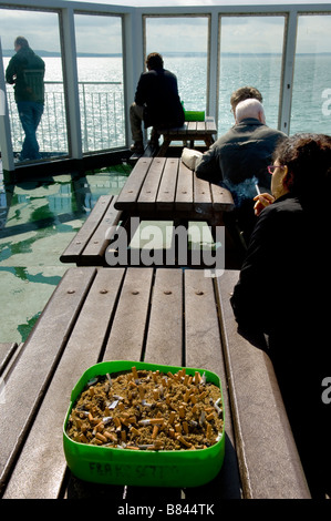 Smokers and ashtray on cross channel ferry Stock Photo