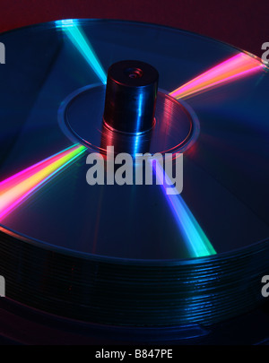 stack of CD's on a spindle lit with red and blue studio lighting Stock Photo