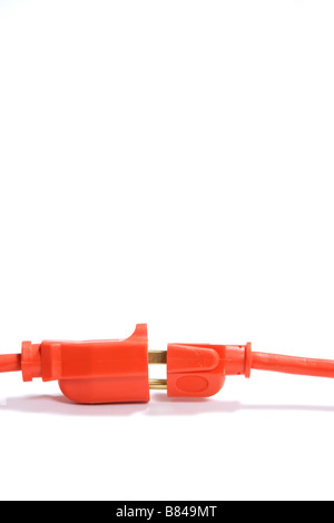 A 100 foot orange extension cord coiled up with a three way splitter Stock Photo